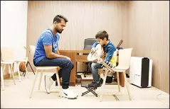  ??  ?? A child training on ‘Oud’ instrument.