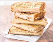  ?? CARL TREMBLAY/AMERICA’S TEST KITCHEN VIA AP ?? Grown-up Grilled Cheese with Cheddar and Shallot is featured in the cookbook “New Essentials.”