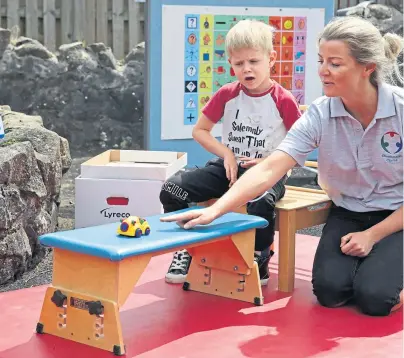  ??  ?? Oliver Cunningham with specialist physiother­apist Leah Honohan