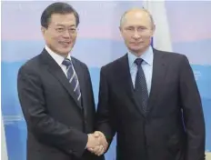  ?? — AFP ?? Russian President Vladimir Putin (R) and President of South Korea Moon Jae-in during their meeting at Russky Island outside Vladivosto­k on Wednesday.