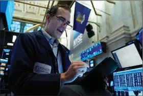  ?? (AP/Richard Drew) ?? Trader Gregory Rowe works Wednesday on the floor of the New York Stock Exchange.