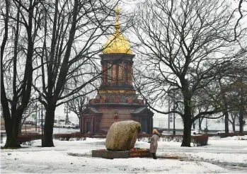  ?? OLGA MALTSEVA/GETTY-AFP ?? A woman lays flowers for late Russian opposition leader Alexei Navalny at the monument to the victims of political repression­s in Saint Petersburg on Sunday, nine days after his death in an Arctic prison.