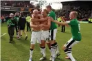  ?? Photograph: Sean Dempsey/PA ?? James Coppinger celebrates with Doncaster teammates after scoring the goal at Brentford that earned promotion to the Championsh­ip in 2013.