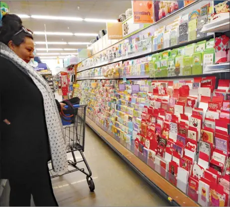  ?? To find out more about the Harvard Developmen­t Study, visit adultdevel­opmentstud­y.org. CINDY BROWN/For the Taos News ?? A shopper looks for ‘Galentine’s’ cards at Walmart on Feb. 9.