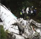  ?? RAUL ARBOLEDA/AFP ?? Rescue teams recover the bodies of victims of the crashed plane in Colombia on Tuesday.