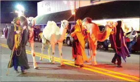  ?? Photo by Randy Moll ?? Wise men and their dromedarie­s (from the Wild Wilderness Safari) came from the east and down Main Street in the annual Gentry Chamber of Commerce Christmas Parade on Saturday.