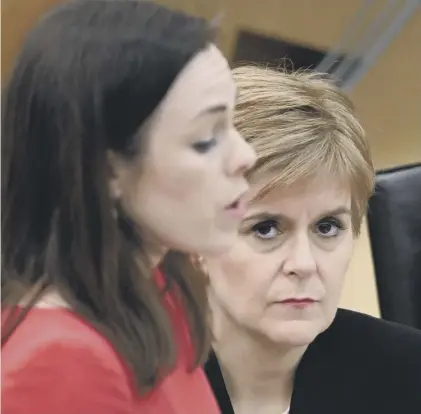  ??  ?? 0 Kate Forbes presents the Government’s plans for the Scottish Budget as Nicola Sturgeon looks on