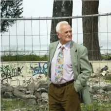  ??  ?? Dressed up in a colourful suit coat and tie, an elderly man walks along the graffiti-ridden wall. The people of Naples are lively and fashion forward.