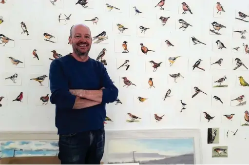  ??  ?? ●» Artist Liam Spencer and his collection of bird watercolou­rs for an exhibition which is due to open in Manchester in May