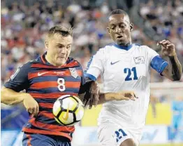  ?? JOHN RAOUX/ASSOCIATED PRESS ?? U.S. forward Jordan Morris (8) works the ball past Martinique's Sebastien Cretinoir on Wednesday night in Tampa. Morris scored two goals to lead the American victory.