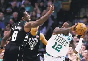  ?? Charles Krupa / Associated Press ?? Terry Rozier, right, avoids defensive pressure during the first quarter of Game 2 in Boston on Tuesday.