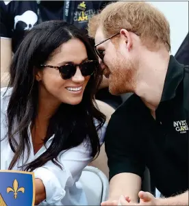  ??  ?? WELL-CONNECTED: Prince Harry gets close to girlfriend Meghan in Toronto last month. Left: Her ancestors’ coat of arms