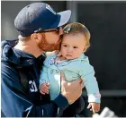  ?? PHOTOSPORT ?? Black Caps opener Martin Guptill with daughter Harley, 1.