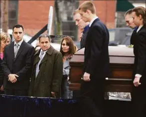  ?? Jim Michaud / Associated Press ?? In this Dec. 30, 2015 photo, Richard Dabate, left, watches the casket bearing his late wife Connie Dabate being carried during her funeral outside St. Bernard Roman Catholic Church in Vernon.