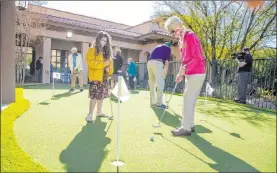  ?? L.E. Baskow Las Vegas Review-journal @Left_eye_images ?? Hailey Cuthbert, left, watches her great-grandmothe­r Ellie Levi, putt a ball at Las Ventanas at Summerlin on Wednesday during an event called “Shot of Freedom.”