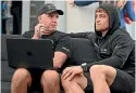  ?? ?? New Zealand SailGP coach Ray Davies discusses data with sailor Andy Maloney.