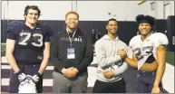  ?? Submitted photo ?? Juan Rosario, second from right shaking hands with UConn safety Omar Fortt, is the latest player from St. Luke’s to commit to play football at UConn. Brendan Casey, a lineman at UConn, is at left next to Jordan Robinson, a junior lineman at St. Luke’s, who is also being recruited by UConn.