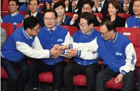  ?? Photograph: YONHAP/EPA ?? Officials of the main opposition Democratic party, including its leader Lee Jae-myung (second from right), react as TV exit polls emerge.