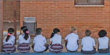  ?? (AP/Bernat Armangue) ?? Pupils wait to wash their hands Friday on the first day of classes at SEK-El Castillo Internatio­nal School in Villafranc­a del Castillo, on the outskirts of Madrid, Spain.