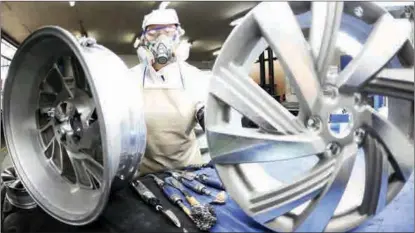  ?? WANG CHUN / FOR CHINA DAILY ?? An employee works on wheel hubs that are manufactur­ed for export at a company in Lianyungan­g, Jiangsu province, on March 18.