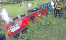  ?? ?? A River Canal Rescue team secure the stricken boat.