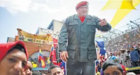  ?? Ariana Cubillos / Associated Press ?? A cutout of the late Venezuelan President Hugo Chavez stands out among supporters Monday during a rally backing the new Constituti­onal Assembly outside the National Assembly building in Caracas, Venezuela.