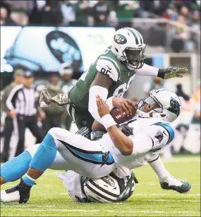  ?? Abbie Parr / Getty Images ?? Jets defensive end Muhammad Wilkerson tackles Panthers quarterbac­k Cam Newton during a game earlier this season.