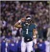  ?? MATT SLOCUM — THE ASSOCIATED PRESS ?? Philadelph­ia Eagles quarterbac­k Jalen Hurts reacts after throwing a touchdown pass to wide receiver DeVonta Smith during the first half of a divisional round playoff game against the New York Giants on Saturday in Philadelph­ia.
