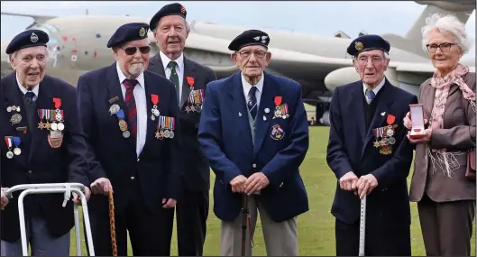  ??  ?? Back on parade: Gordon Collinson, 91, Gerry Briscoe, 90, Bill Wright, 90, Eric Gill, 99, James Denwood, 97, and widow Catherine Rush, 83