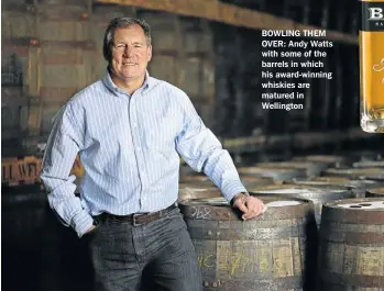  ??  ?? BOWLING THEM OVER: Andy Watts with some of the barrels in which his award-winning whiskies are matured in Wellington