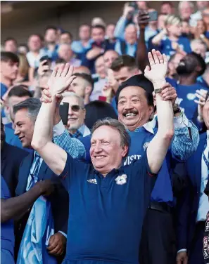  ?? — Reuters ?? He’s the man: Cardiff owner Tan Sri Vincent Tan raising manager Neil Warnock’s hands in jubilation as they celebrate the team’s promotion to the Premier League on Sunday.