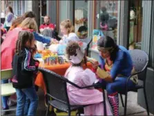  ?? MICHILEA PATTERSON — FOR DIGITAL FIRST MEDIA ?? Children in costume get face paintings during the annual Haunts on High event in Pottstown. Kids are encouraged to dress in costume then visit vendor tables and businesses for candy and other activities.