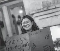  ?? Billy Calzada / Staff photograph­er ?? Melissa Rodriguez, 18, who has been in foster care, holds a sign of gratitude during a party at at La Hacienda Scenic Loop.