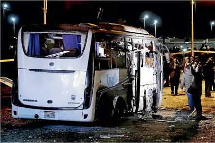  ?? AP ?? Egyptian security forces inspect a tourist bus after it was hit by a roadside bomb near the Giza Pyramids, in the first militant attack targeting foreign tourists in almost two years.