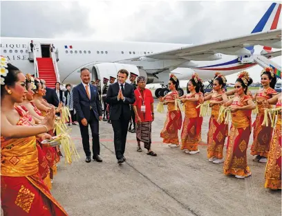  ?? Picture: AFP ?? ALOHA. French President Emmanuel Macron, centre, arrives before the G20 Summit at Ngurah Rai internatio­nal airport in Denpasar, on the Indonesian resort island of Bali, yesterday.