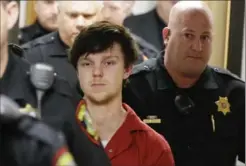  ?? L.M. OTERO, THE ASSOCIATED PRESS ?? Ethan Couch is led away by sheriff deputies after a juvenile court hearing on Friday in Fort Worth, Texas. A judge ruled Couch, who used an “affluenza” defence in a fatal drunken-driving crash, will be moved to adult court, meaning he could face jail time.