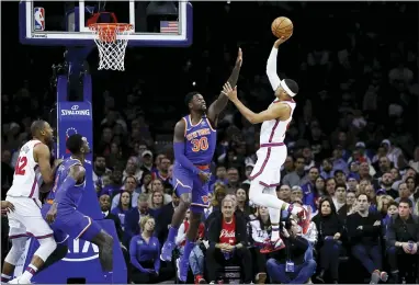  ?? MATT SLOCUM — THE ASSOCIATED PRESS ?? The 76ers’ Tobias Harris, right, goes up for a shot against New York’s Julius Randle during the first half on Thursday at the Wells Fargo Center. Harris scored 34 points to lead the Sixers to a win.
