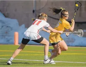  ?? KARL MERTON FERRON/BALTIMORE SUN ?? Bryn Mawr attacker Alex Marino cuts past Roland Park defender Keeley McNemar. Marino was one of seven Mawrtians to score in the team’s fourth victory of the season.