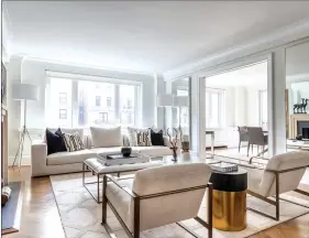  ??  ?? A living room shines with the help of a black-and-white palette blended with brass accents. (Design Recipes)