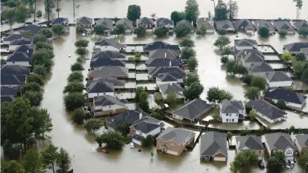  ?? DAVID J. PHILLIP/AP ?? Homes in Spring, Texas, stand in floodwater­s from 2017’s Tropical Storm Harvey. Risks to private water wells are elevated after such flooding.