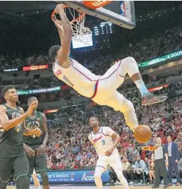  ?? DAVID SANTIAGO/TNS ?? Hassan Whiteside, here dunking against the Bucks, combined with Bam Adebayo for 27 points and 26 rebounds on Friday night.