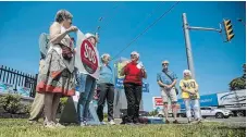  ?? BOB TYMCZYSZYN TORSTAR ?? Niagara Health Coalition chair Sue Hotte, wearing red, speaks at a rally against health-care cuts in front of St. Catharines hospital Tuesday.