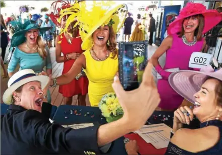  ?? PETE BANNAN – DIGITAL FIRST MEDIA ?? Television personalit­y Carson Kressley, left, takes a selfie with Devon ladies group hat winners: Sharon Bozentka, Joanne Bogan, obscured, Anette Brennan, Tina Aberant and judge Caroline O’Halloran, bottom right. More than 125 area women sporting their...