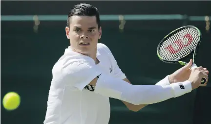  ?? TIM IRELAND/THE ASSOCIATED PRESS ?? Milos Raonic returns a shot to Daniel Gimeno-Traver of Spain in their first-round match at Wimbledon Monday.