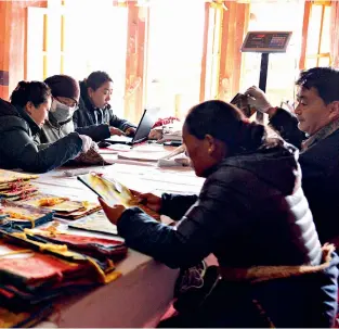  ??  ?? Workers filing results of a general survey of silk fabrics of Potala Palace on April 12, 2016. The Potala Palace has a rich collection of cultural relics, including some 100,000 ancient books and documents.