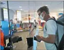  ?? LM OTERO - THE ASSOCIATED PRESS ?? Amid concerns of the spread of COVID-19, a cashier and customer are separated by plexiglass at the city owned waterpark in Grand Prairie, Texas, Friday, May 29. Water parks in Texas were allowed to reopen today.