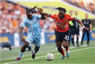  ?? ?? Coventry City’s Fankaty Dabo (left) in action with Luton Town’s Fred Onyedinma. — reuters