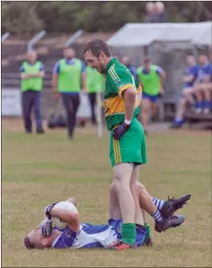  ??  ?? Annacurra’s Shane McAllister checks on the wellbeing of Paul O’Brien.