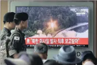  ??  ?? South Korean army soldiers watch a TV news programme at Seoul Railway Station showing a file image of a missile being test-launched by North Korea. PICTURE: AP