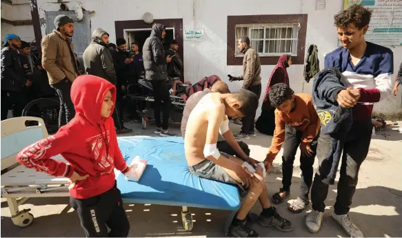  ?? AFP ?? Young Palestinia­ns receive medical care at Kamal Adwan Hospital in Beit Lahia, in northern Gaza, on Thursday after Israeli soldiers fired on people waiting for aid